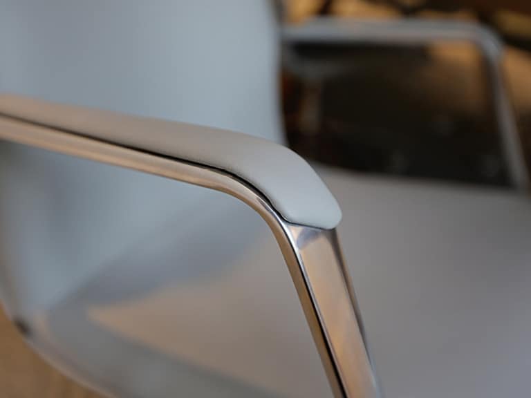 A close up of the arm of a metal chair
