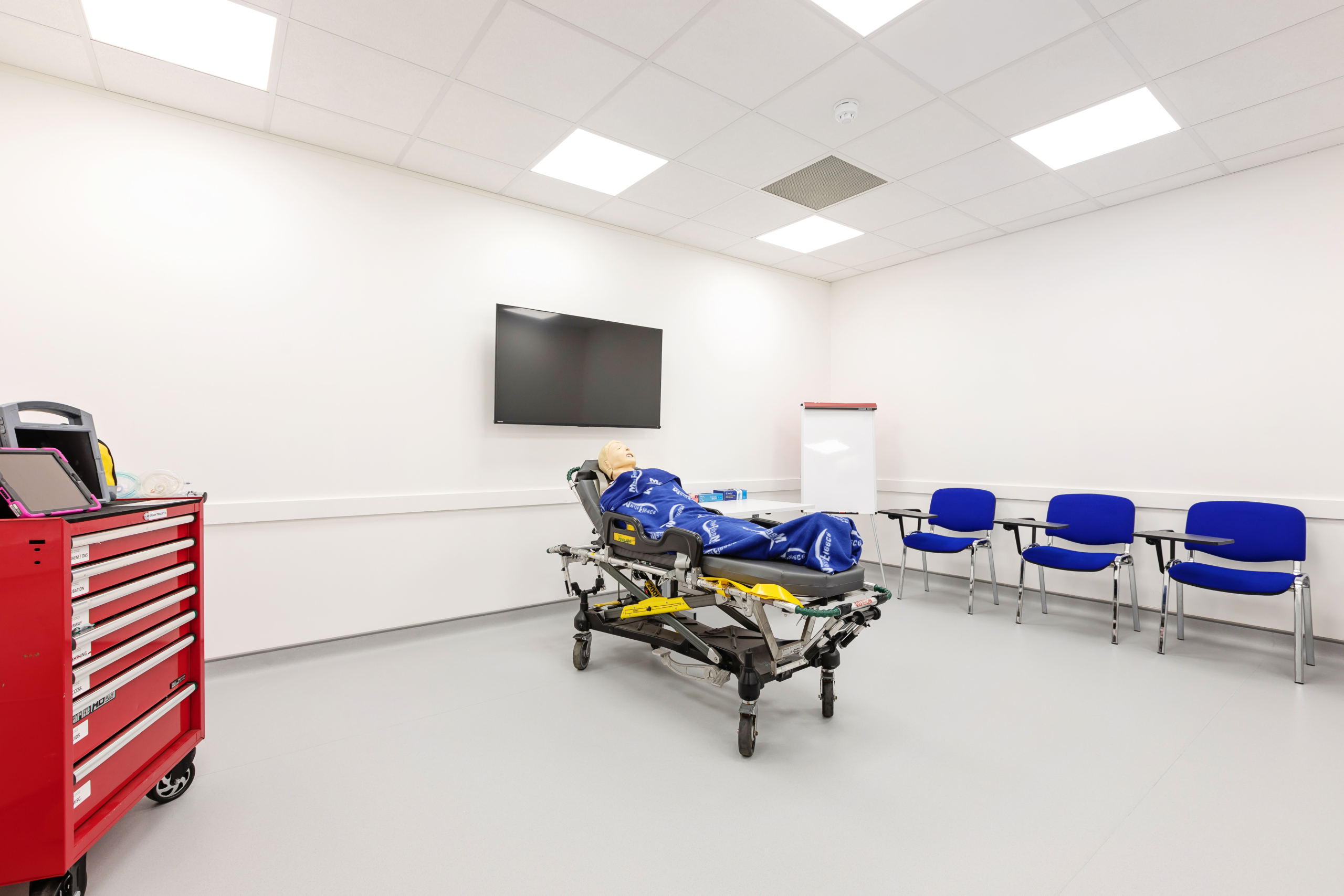 Open training room with training dummy doll and seating area