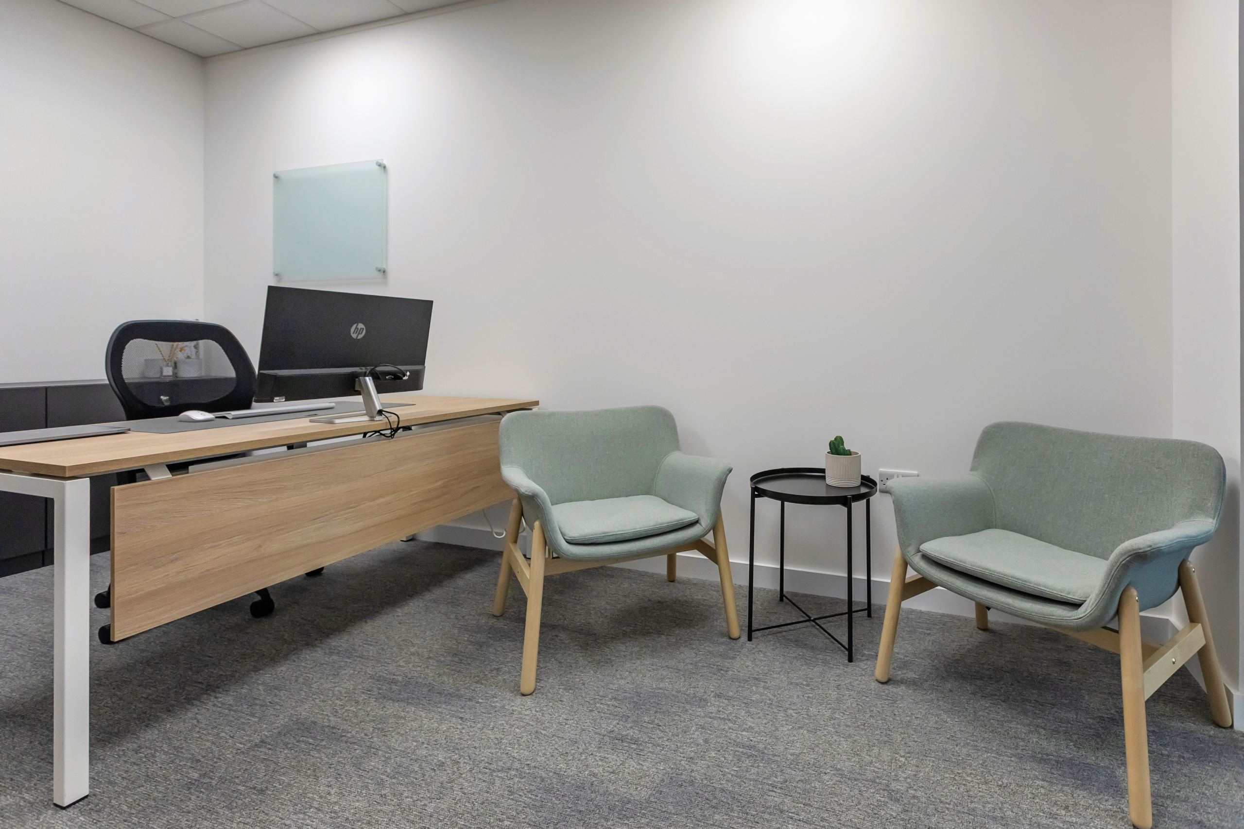 Private clinical room with desk and patient seating