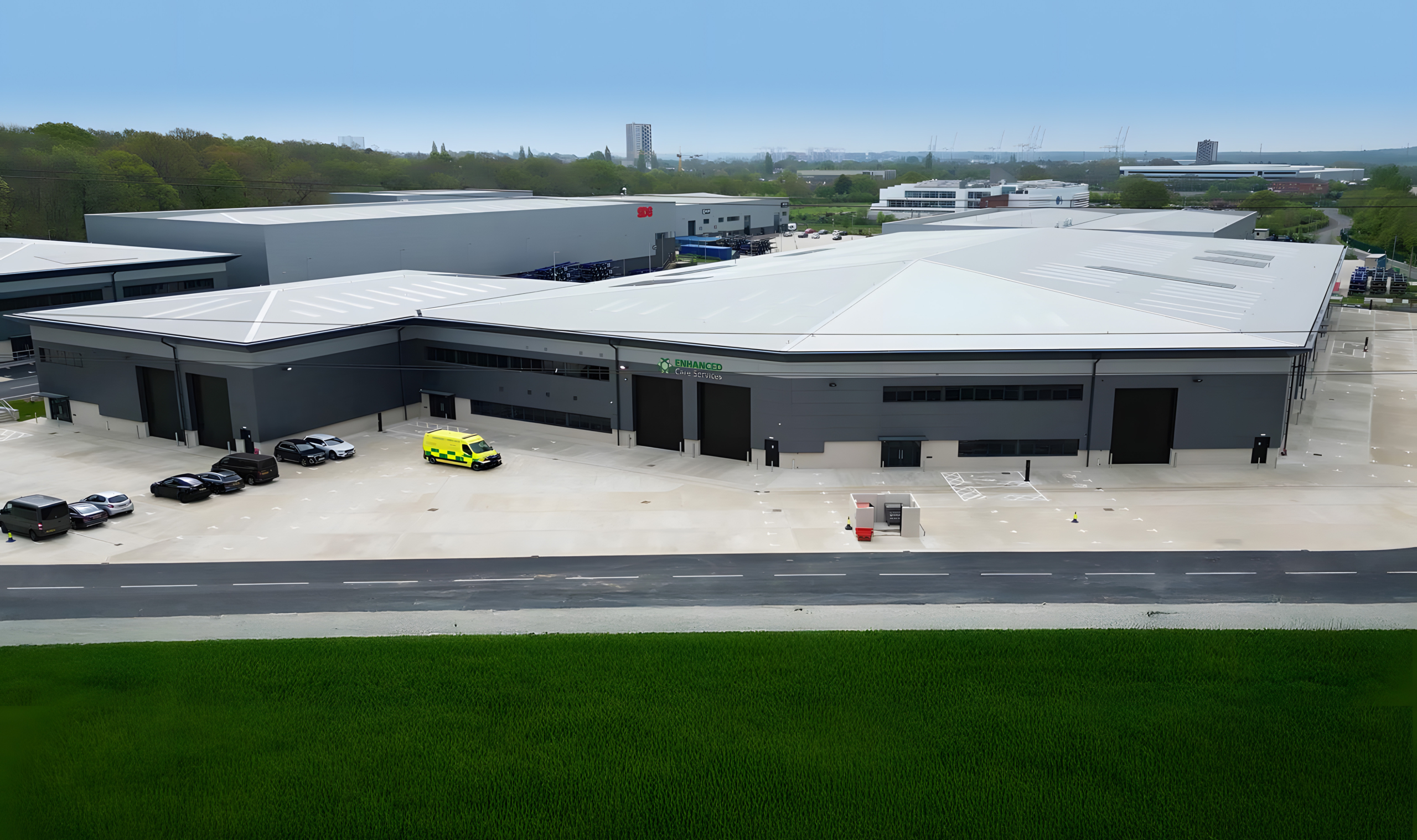 External shot of industrial warehouse building and ambulances outside