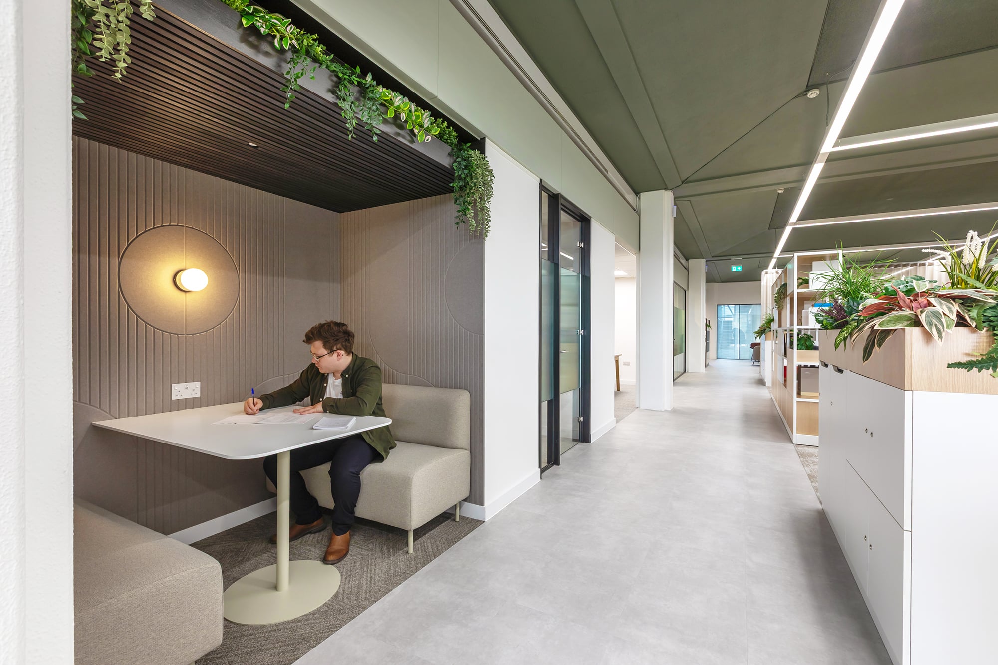 A colleague works in a breakout area in an open plan office