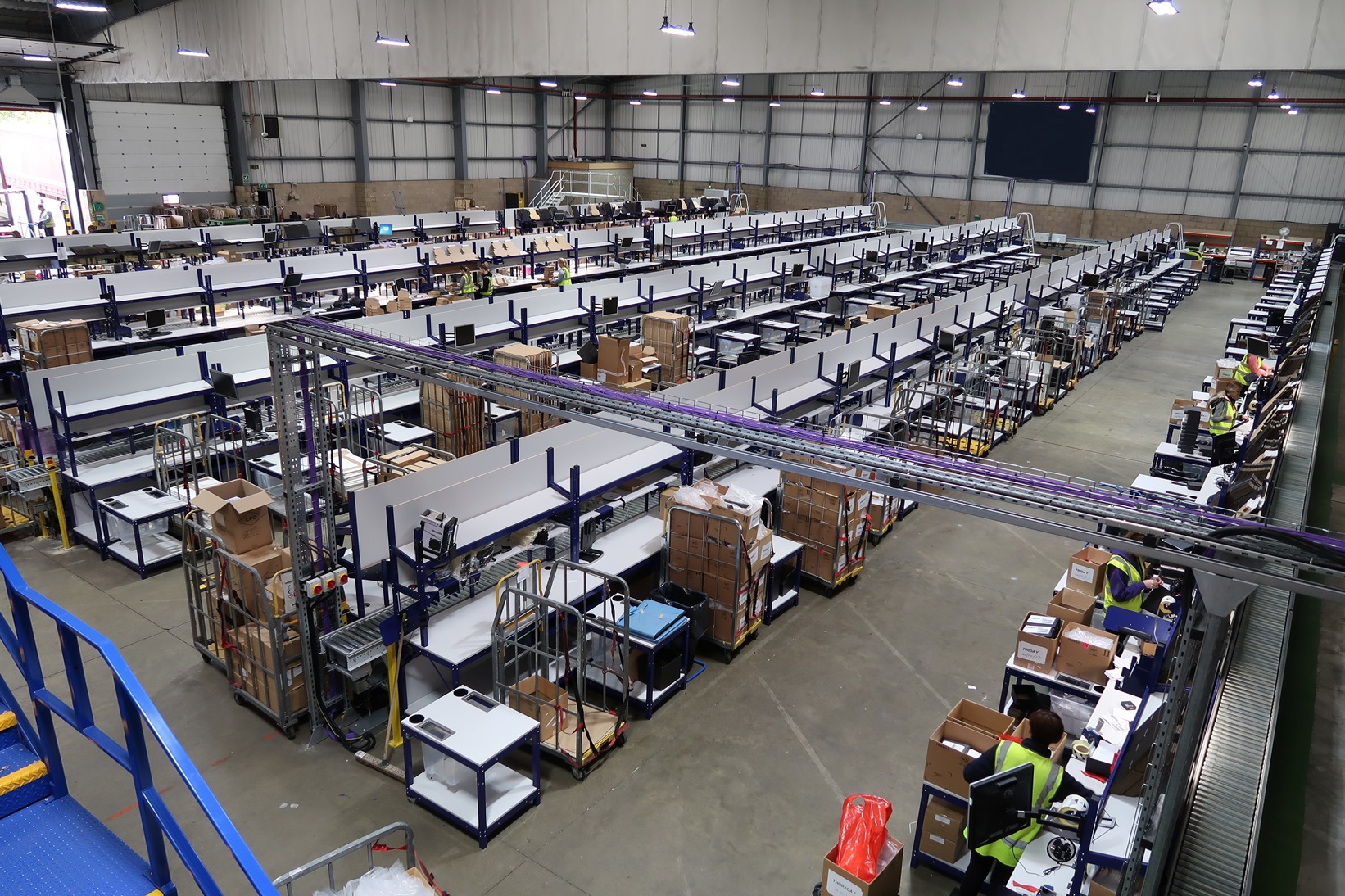 Overhead shot of picking and packing area, with racking and boxes